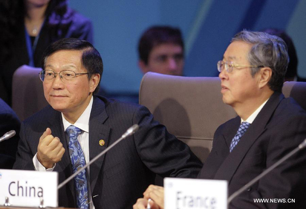 Chinese Finance Minister Xie Xuren (L) and Governor of People&apos;s Bank of China Zhou Xiaochuan attend a meeting of the Group of 20 (G20) Meeting of Finance Ministers and Central Bank Governors in Moscow, Russia, Feb. 16, 2013. The two-day meeting concluded here on Saturday.