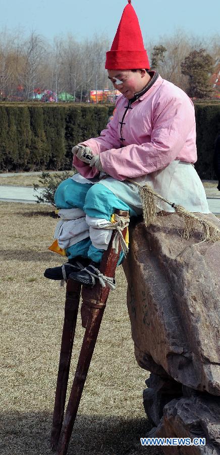 File photo taken on April 1, 2012 shows Shehuo performers stage a stilt show during a Qingming Festival parade in Kaifeng, central China's Henan Province.