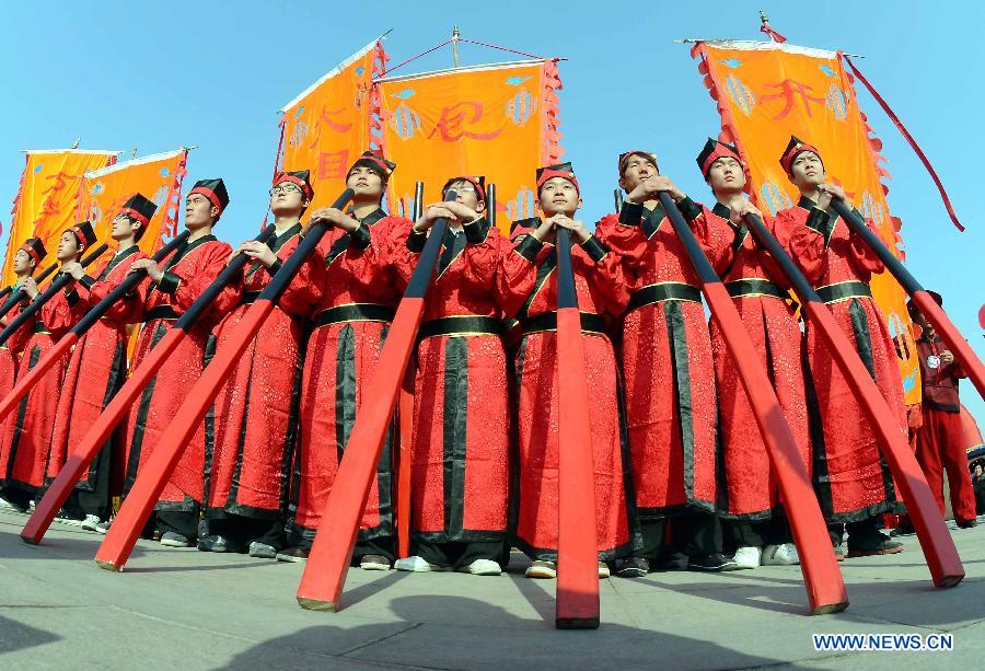 File photo taken on April 1, 2012 shows Shehuo performers stage a stilt show during a Qingming Festival parade in Kaifeng, central China's Henan Province.