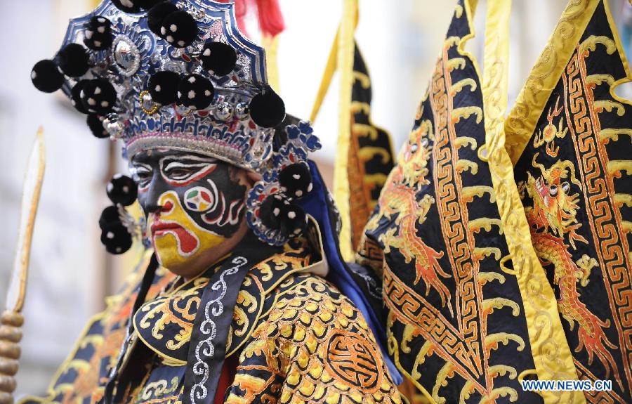 A performer in traditional Chinese opera costume participates in a parade celebrating the Lunar New Year in the Chinatown in Yokohama, Japan, Feb. 17, 2013.