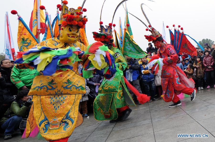 Performers perform Nuo dance, a kind of exorcising dance, during the 14th Folk Culture Festival in Liyang City, east China's Jiangsu Province, Feb. 17, 2013.