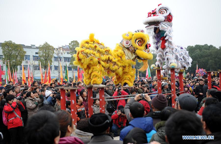 Performers perform Nuo dance, a kind of exorcising dance, during the 14th Folk Culture Festival in Liyang City, east China's Jiangsu Province, Feb. 17, 2013.