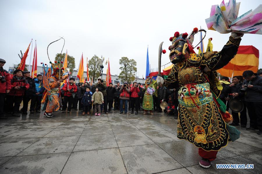 Performers perform Nuo dance, a kind of exorcising dance, during the 14th Folk Culture Festival in Liyang City, east China's Jiangsu Province, Feb. 17, 2013.