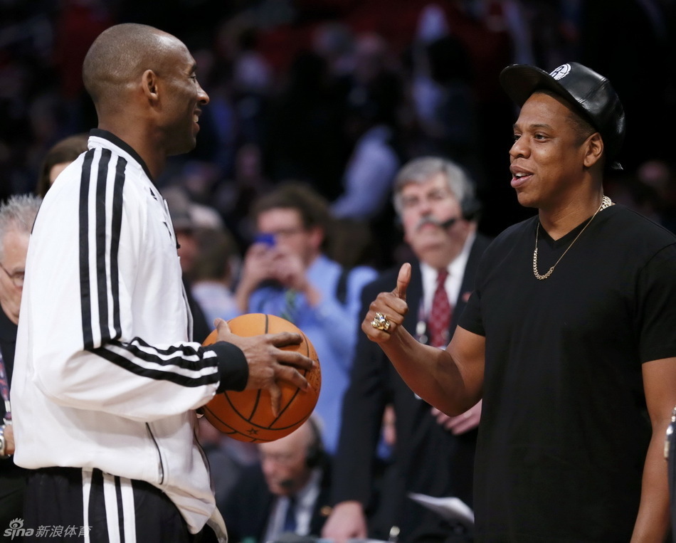 Music artist Jay-Z talks to Kobe Bryant before the 2013 NBA All-Star Game in Houston, Texas, February 17, 2013.