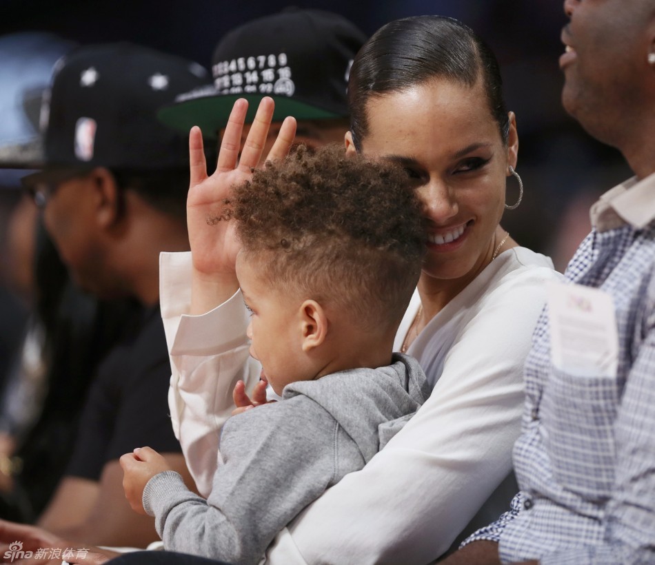 Music artist Alicia Keys and her son watch the 2013 NBA All-Star Game in Houston, Texas, February 17, 2013.