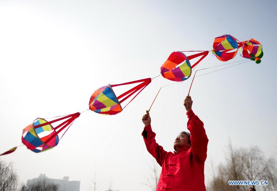 A man plays diabolo at a park in Lanzhou, capital of northwest China's Gansu Province, Feb. 19, 2013. 