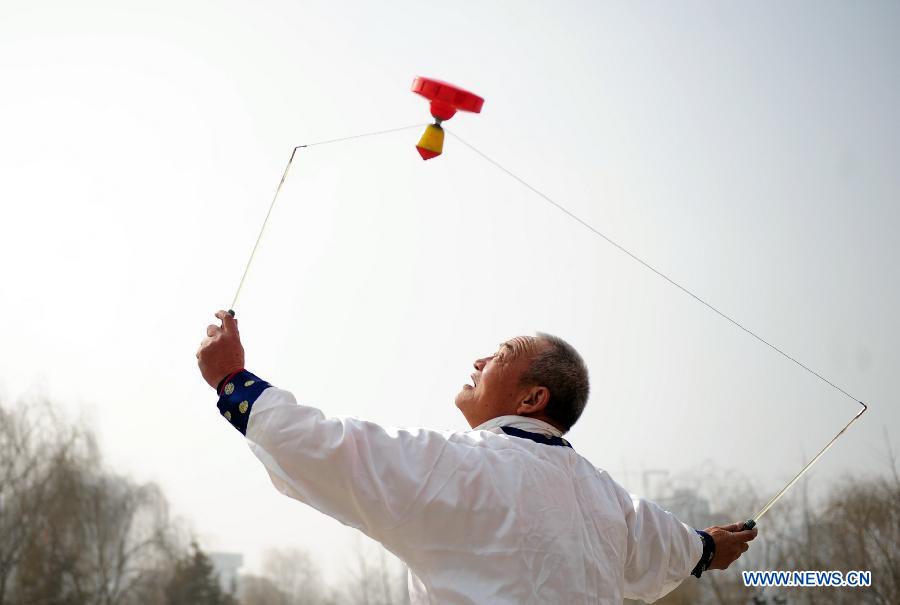 A man plays diabolo at a park in Lanzhou, capital of northwest China's Gansu Province, Feb. 19, 2013.