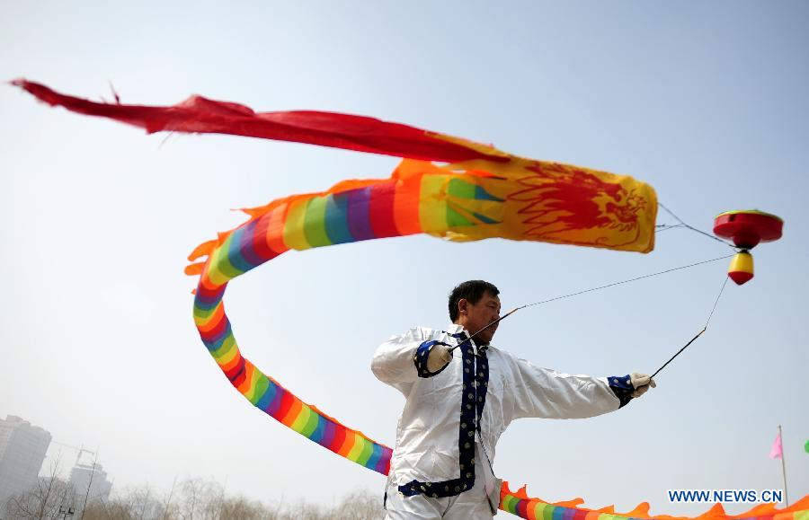 A man plays diabolo at a park in Lanzhou, capital of northwest China's Gansu Province, Feb. 19, 2013. 