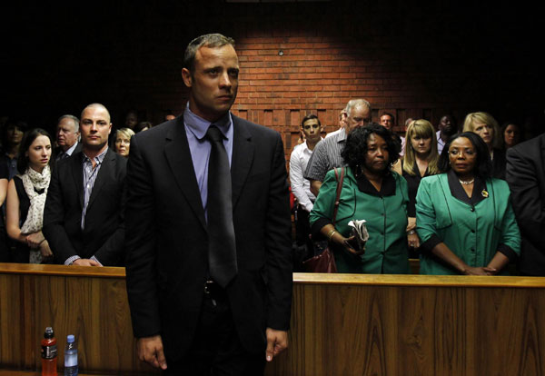 'Blade Runner' Oscar Pistorius awaits the start of court proceedings in the Pretoria Magistrates court, Feb 19, 2013. [China Daily via agencies]