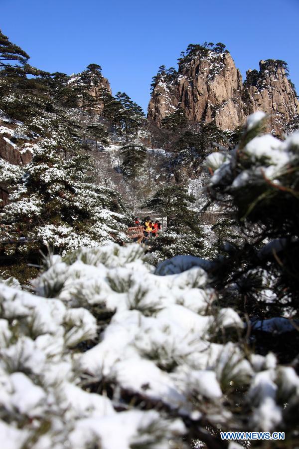 Tourists visit the Huangshan Mountain scenic area after a snow in east China's Anhui Province, Feb. 20, 2013. 