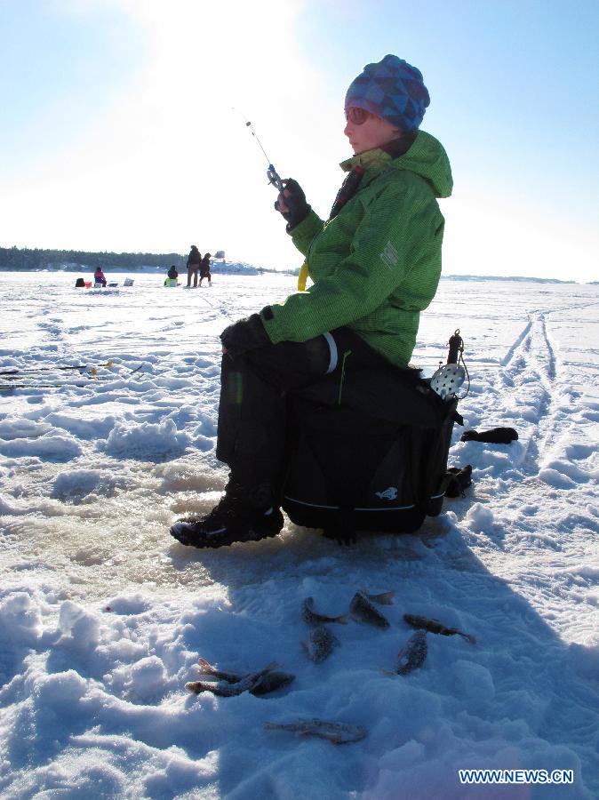 A child takes part in an ice fishing contest in Mustikkamaa, Helsinki, Finland, on Feb. 25, 2013.