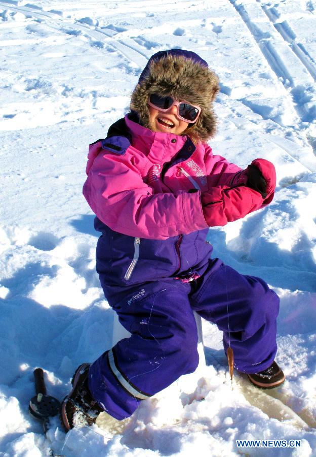 A child takes part in an ice fishing contest in Mustikkamaa, Helsinki, Finland, on Feb. 25, 2013. 