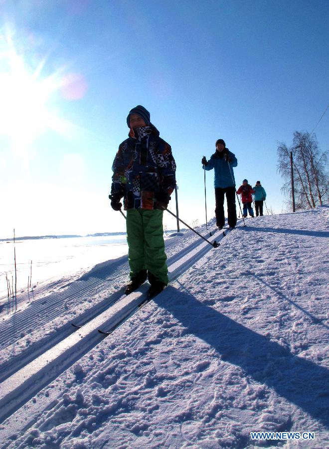 Children ski on a hillside in Mustikkamaa, Helsinki, Finland, on Feb. 25, 2013.