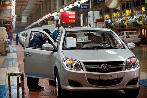 Workers assemble cars at a workshop at Zhejiang Geely Holding Group. [Beijing Review/CFP] 