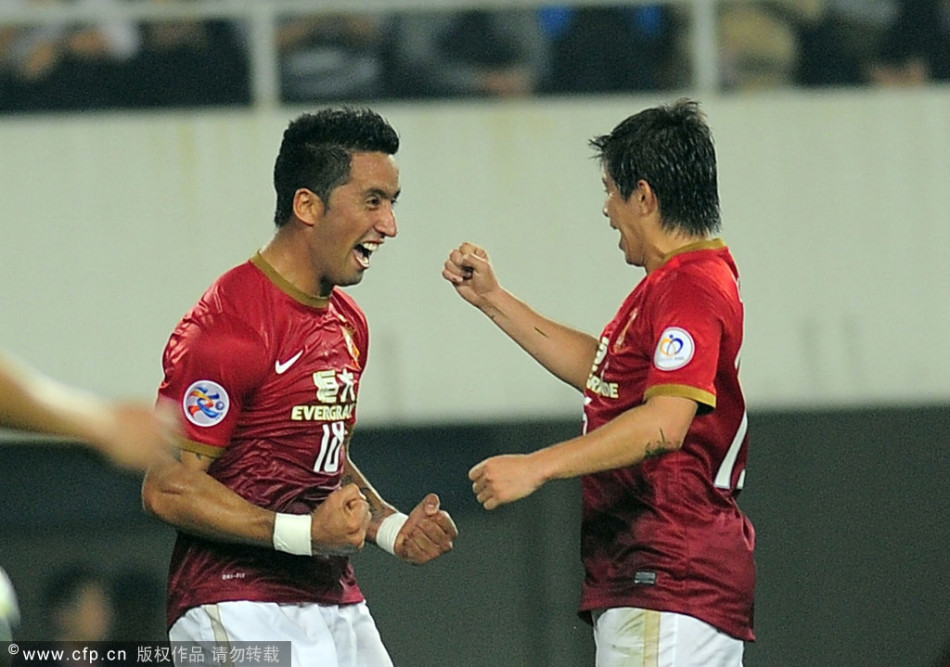 Guangzhou Evergrande's Lucas Barrios celebrates with teammate Dario Conca after scoring the opener against Urawa Red Diamonds in a Group F match of AFC Champions League in Tianhe Stadium, Guangzhou, on Feb.26, 2013.
