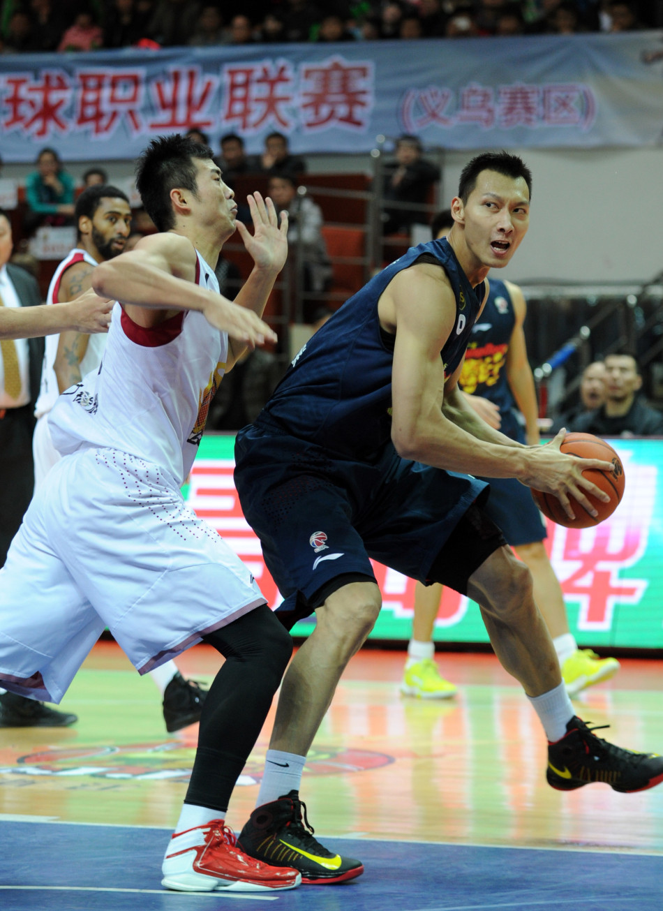 Yi Jianlian of Guangdong Hongyuan plays one on one against Ding Jinhui of Zhejiang in the first round of CBA playoffs in Yiwu, Zhejiang, on Feb.27, 2013.