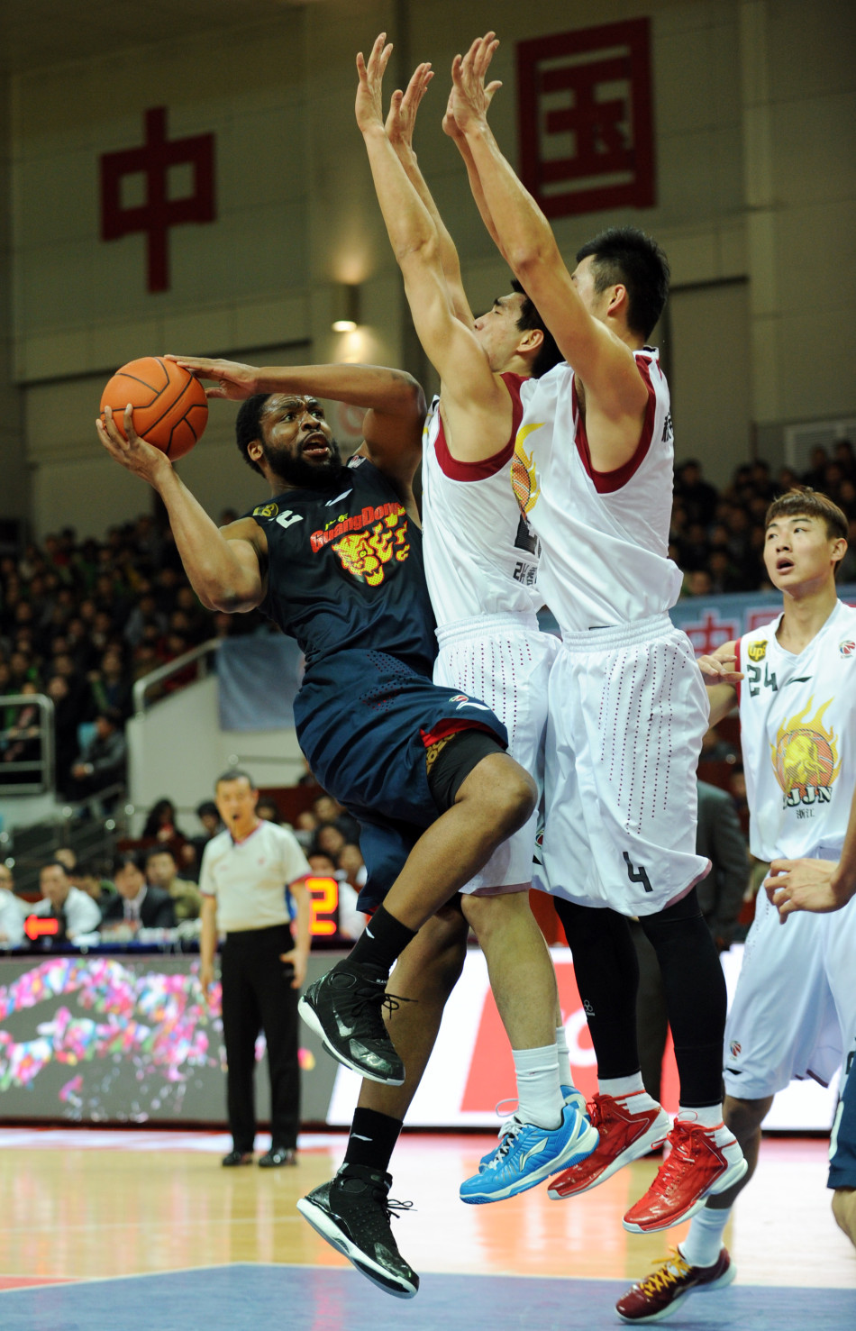 Ike Diogu of Guangdong Hongyuan goes up for a basket against Zhejiang's defenders in the first round of CBA playoffs in Yiwu, Zhejiang, on Feb.27, 2013.