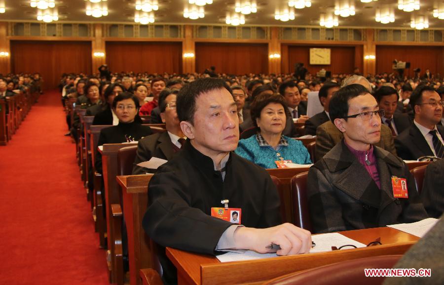 Jackie Chan (front), a member of the 12th National Committee of the Chinese People's Political Consultative Conference (CPPCC), attends the opening meeting of the first session of the 12th CPPCC National Committee at the Great Hall of the People in Beijing, capital of China, March 3, 2013.