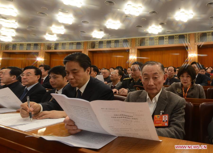Mei Baojiu (R front), a member of the 12th National Committee of the Chinese People's Political Consultative Conference (CPPCC), attends the opening meeting of the first session of the 12th CPPCC National Committee at the Great Hall of the People in Beijing, capital of China, March 3, 2013. 