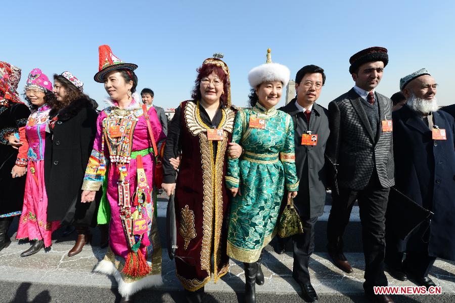 Members of the 12th National Committee of the Chinese People's Political Consultative Conference (CPPCC) walk to the Great Hall of the People in Beijing, capital of China, March 3, 2013.