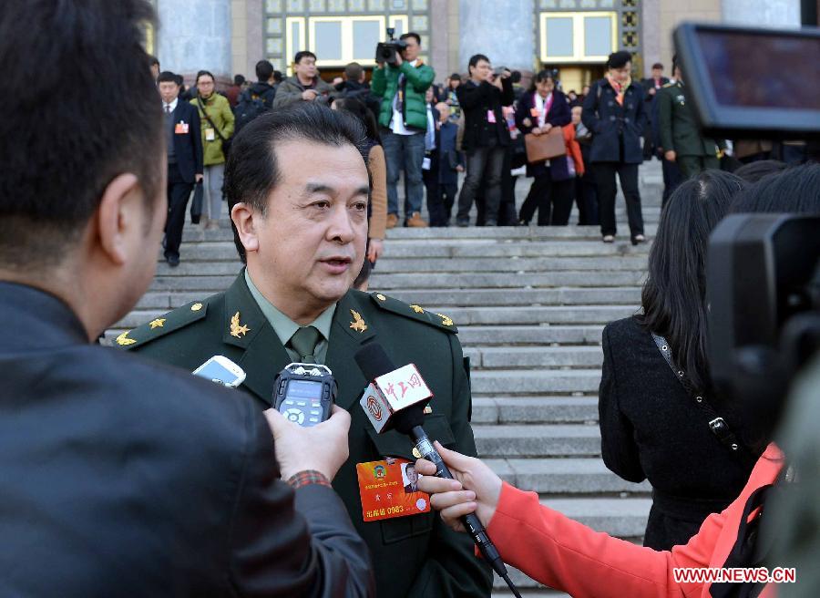 Huang Hong, a member of the 12th National Committee of the Chinese People's Political Consultative Conference (CPPCC), receives interview outside the Great Hall of the People in Beijing, capital of China, March 3, 2013. 