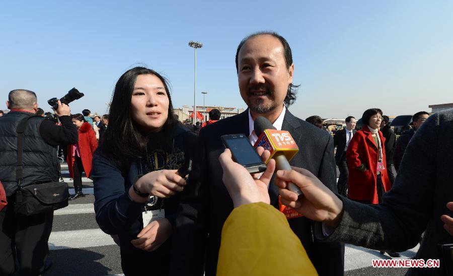 Tenggel, a member of the 12th National Committee of the Chinese People's Political Consultative Conference (CPPCC), receives an interview outside the Great Hall of the People in Beijing, capital of China, March 3, 2013. 