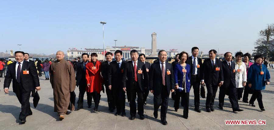 Members of the 12th National Committee of the Chinese People's Political Consultative Conference (CPPCC) walk to the Great Hall of the People in Beijing, capital of China, March 3, 2013. 