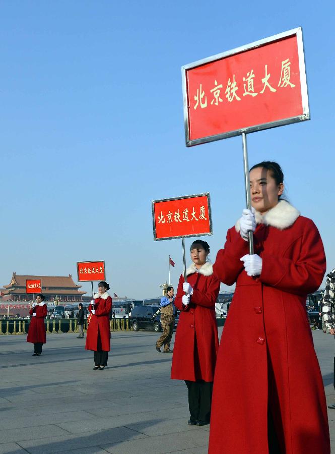 Staff members work at the Tian'anmen Square in Beijing, capital of China, March 3, 2013.