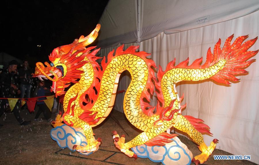 Residents watch the lanterns during the celebration of Chinese Lantern Festival in New Zealand's Christchurch, March 2, 2013. 