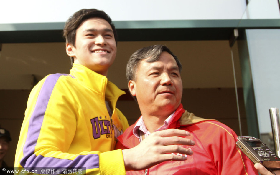 Chinese swimmer Sun Yang (left) hugs his coach Zhu Zhigen in front of a media session before his training in Hangzhou, Zhejiang province, on Monday. The pair appear to reunite after reportedly becoming embroiled in a dispute last month. 