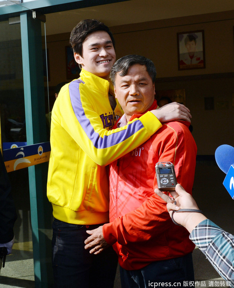 Chinese swimmer Sun Yang (left) hugs his coach Zhu Zhigen in front of a media session before his training in Hangzhou, Zhejiang province, on Monday. The pair appear to reunite after reportedly becoming embroiled in a dispute last month. 