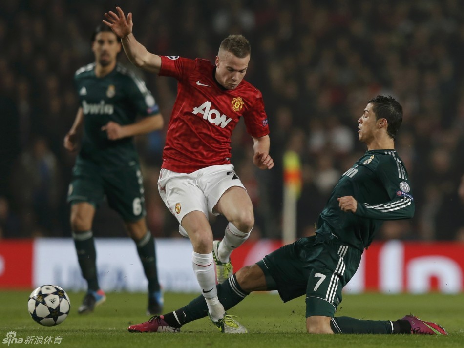 Ronaldo slides in on Cleverley (left) in the first half.