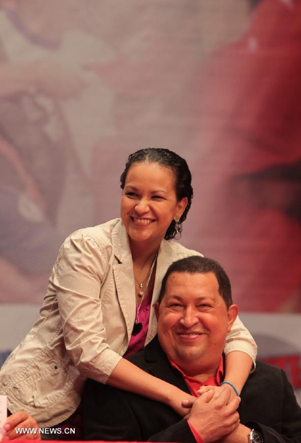 File photo taken on Feb. 23, 2012 shows Venezuelan President Hugo Chavez and his daughter Rosa posing during a party in Caracas, Venezuela. Venezuelan government confirmed President Hugo Chavez&apos;s death on March 5, 2013.