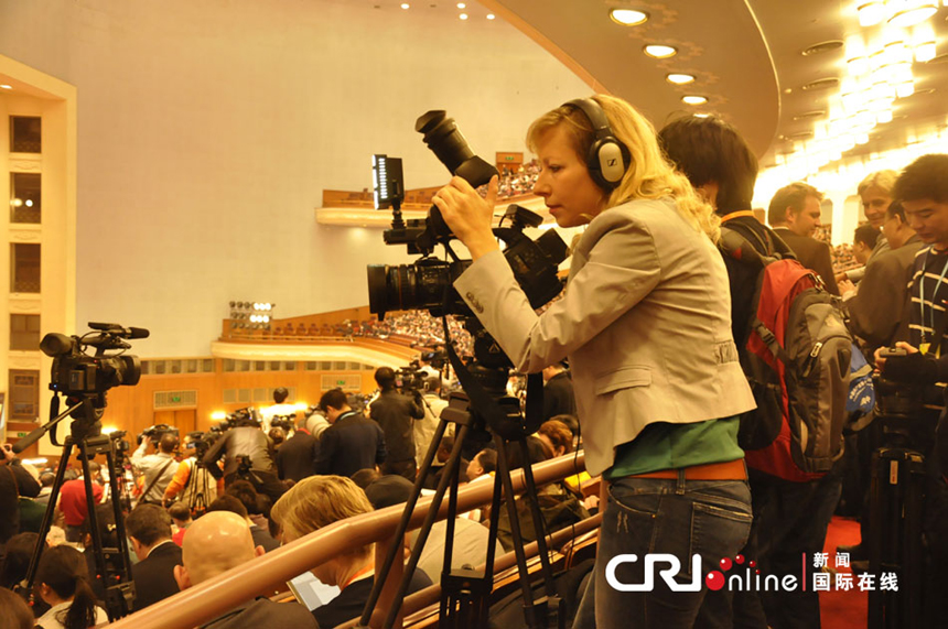 A foreign reporter takes picture in the Great Hall of the People on March 5, 2013. 