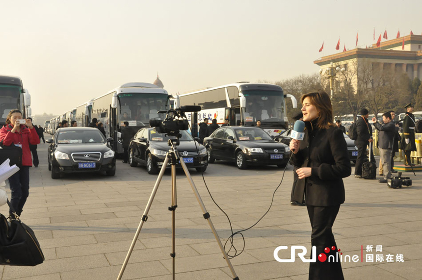 A foreign journalist reports near the Great Hall of the People on March 5, 2013. 