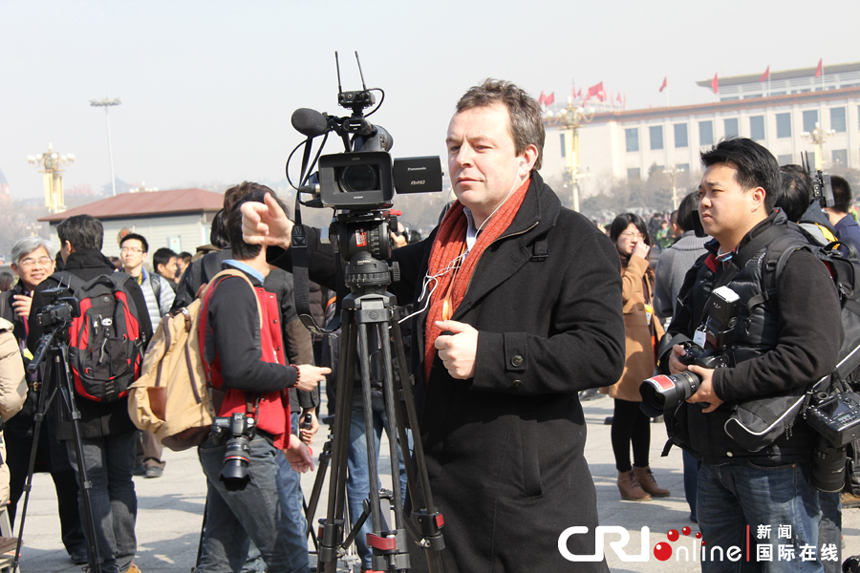 Foreign journalists report China’s political meetings near the Great Hall of the People in Beijing on March 3, 2013.