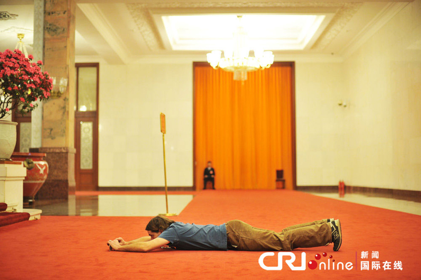 A foreign journalist takes pictures at the Great Hall of the People in Beijing on March 7, 2013.