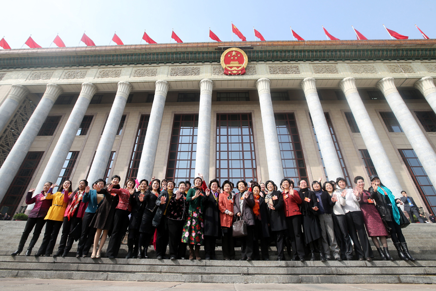 Women delegates pose for a picture after the third plenary meeting of the first session of the 12th National Committee of the Chinese People's Political Consultative Conference (CPPCC) is held at the Great Hall of the People in Beijing, , March 8, 2013.