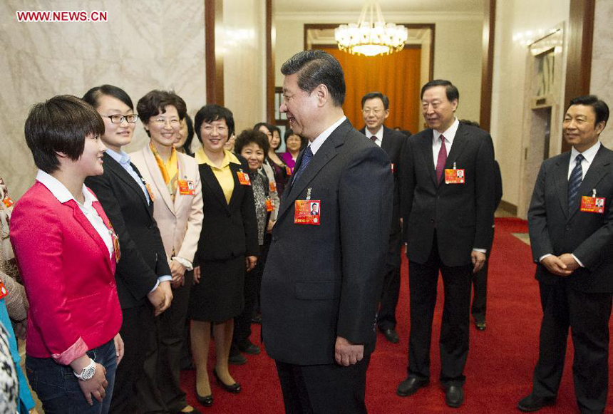 Xi Jinping (C), general secretary of the Central Committee of the Communist Party of China (CPC), talks with Chen Ruolin, the youngest deputy to the 12th National People's Congress (NPC), in Beijing, capital of China, March 8, 2013. 