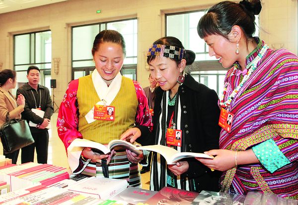 Women deputies from the Tibetan Autonomous Region attending the First Session of the 12th National People's Congress, pick out a book in a Beijing shop on March 8 as a present for International Women's Day. 
