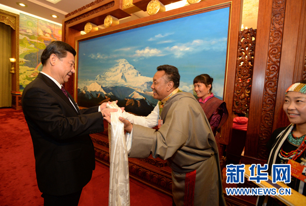 Xi Jinping (L), general secretary of the Central Committee of the Communist Party of China (CPC), receives a hada, a white silk scarf symbolizing respect and blessing, from a deputy to the 12th National People's Congress (NPC) from southwest China's Tibet Autonomous Region, in Beijing, capital of China, March 9, 2013. Xi joined a discussion with the Tibet delegation attending the first session of the 12th NPC in Beijing on Saturday. (Xinhua