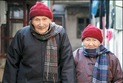 Zhang Mucheng (left), 104, and wife Xu Dongying, 105 are seen outside their house. This photo was taken in 2011.