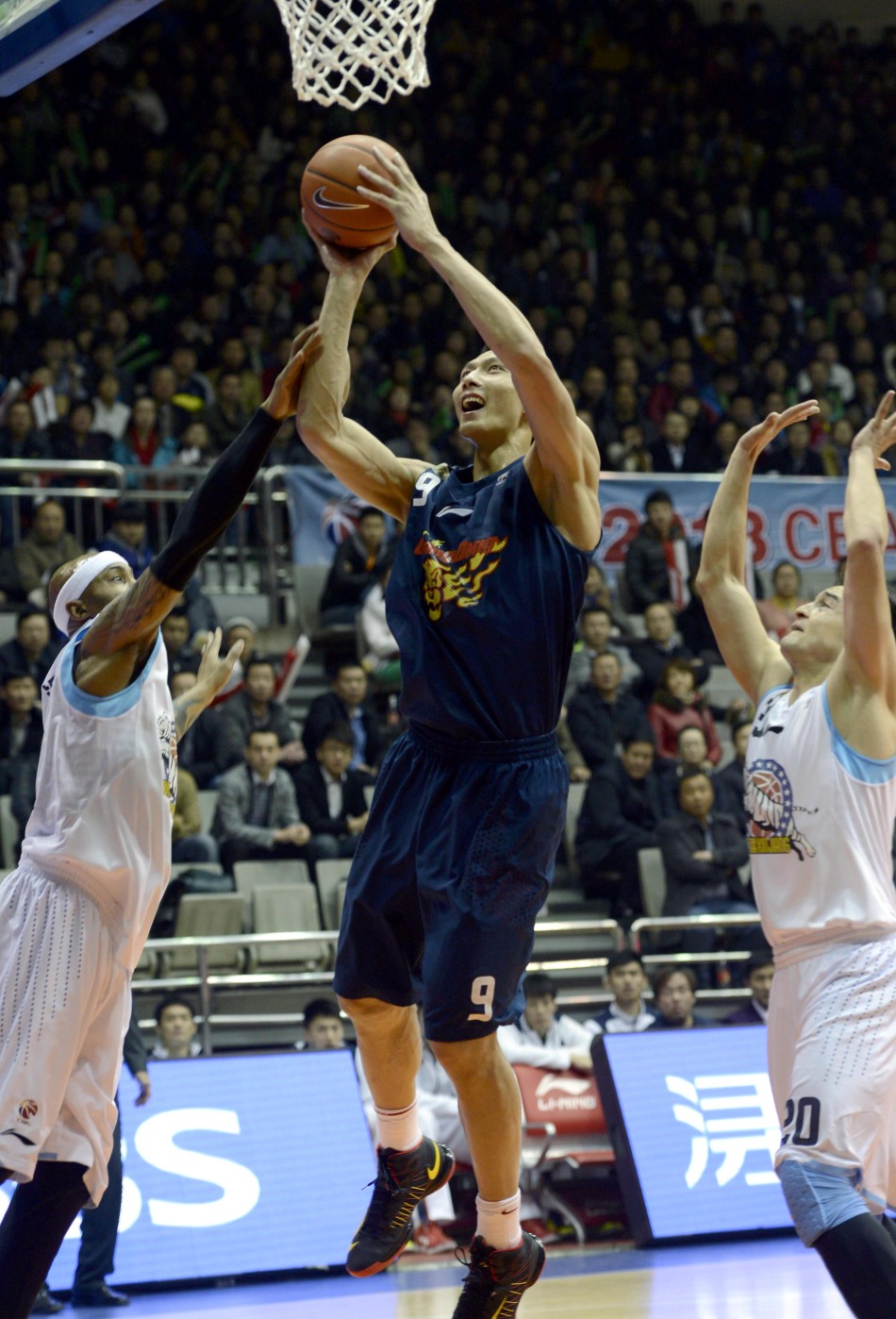 Yi Jianlian of Guangdong Hongyuan goes up for a basket in Game 1 of CBA semifinals between Guangdong and Xinjiang on March 10, 2013. 