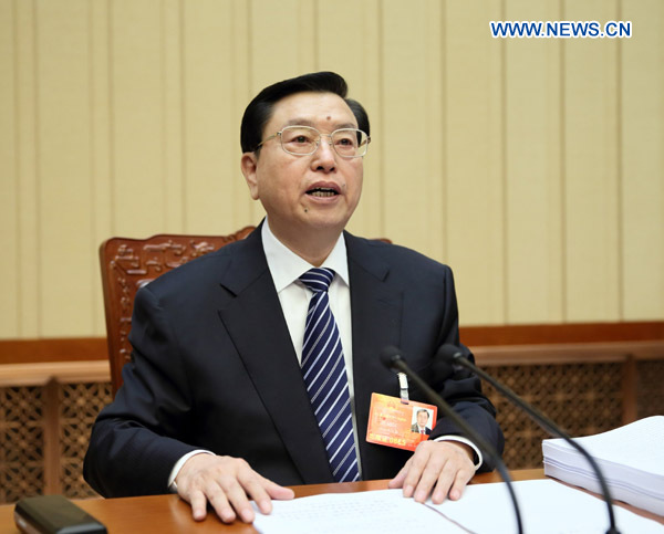 Zhang Dejiang, executive chairperson of the presidium of the first session of the 12th National People's Congress (NPC), presides over the third meeting of the presidium at the Great Hall of the People in Beijing, capital of China, March 12, 2013. (Xinhua