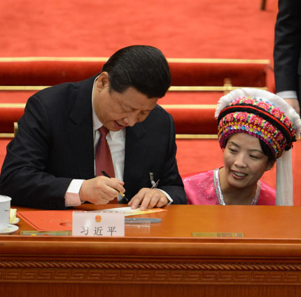 A lawmaker asks newly elected Chinese President Xi Jinping for their autographs after yesterday's elections during the 12th National People's Congress in the Great Hall of the People in Beijing.