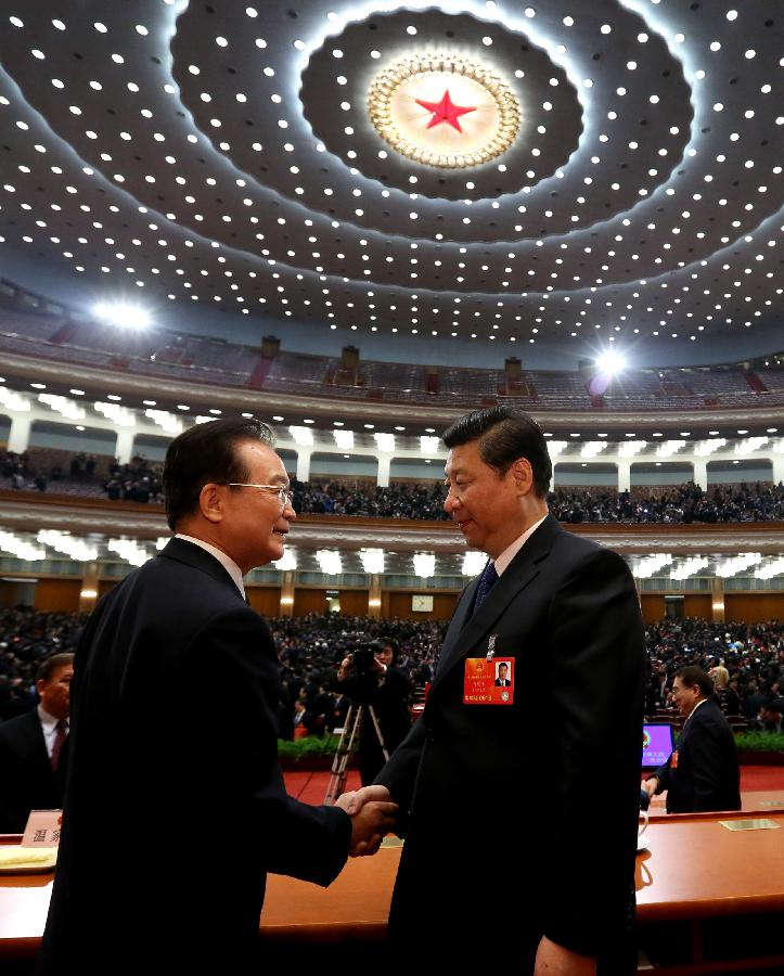 Xi Jinping (R) shakes hands with Wen Jiabao at the fifth plenary meeting of the first session of the 12th National People's Congress (NPC) at the Great Hall of the People in Beijing, capital of China, March 15, 2013. (Xinhua/Lan Hongguang)