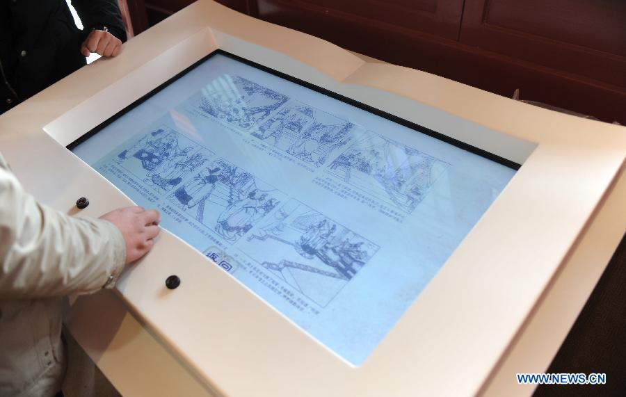 Tourists read e-books at the Jian'an Literature Museum in Linzhang County, north China's Hebei Province, March 14, 2013. 