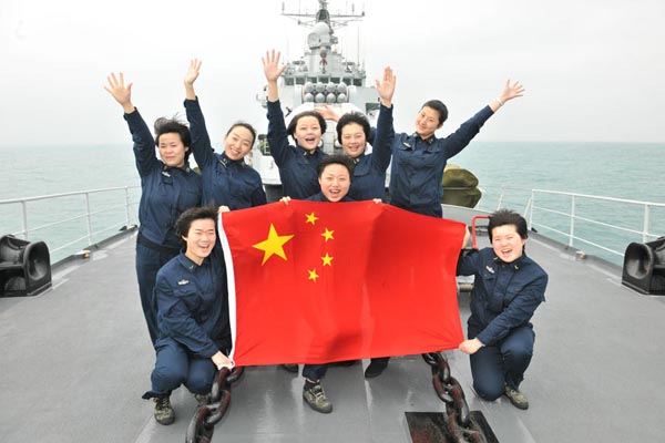 Group photo of the eight female sailors who work combat posts on the 'Harbin' missile destroyer. [Photo by Wang Changsong]