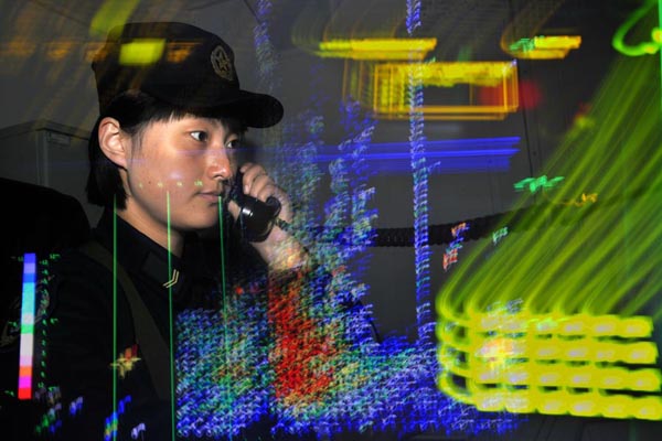 Female sailor Kong Xiangyun works on her combat post. [Photo by Wang Changsong]