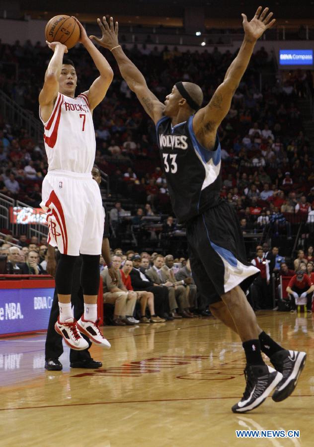 Jeremy Lin (L) of Houston Rockets shoots during the NBA basketball game against Minnesota Timberwolves in Houston, the United States, on March 15, 2013. 